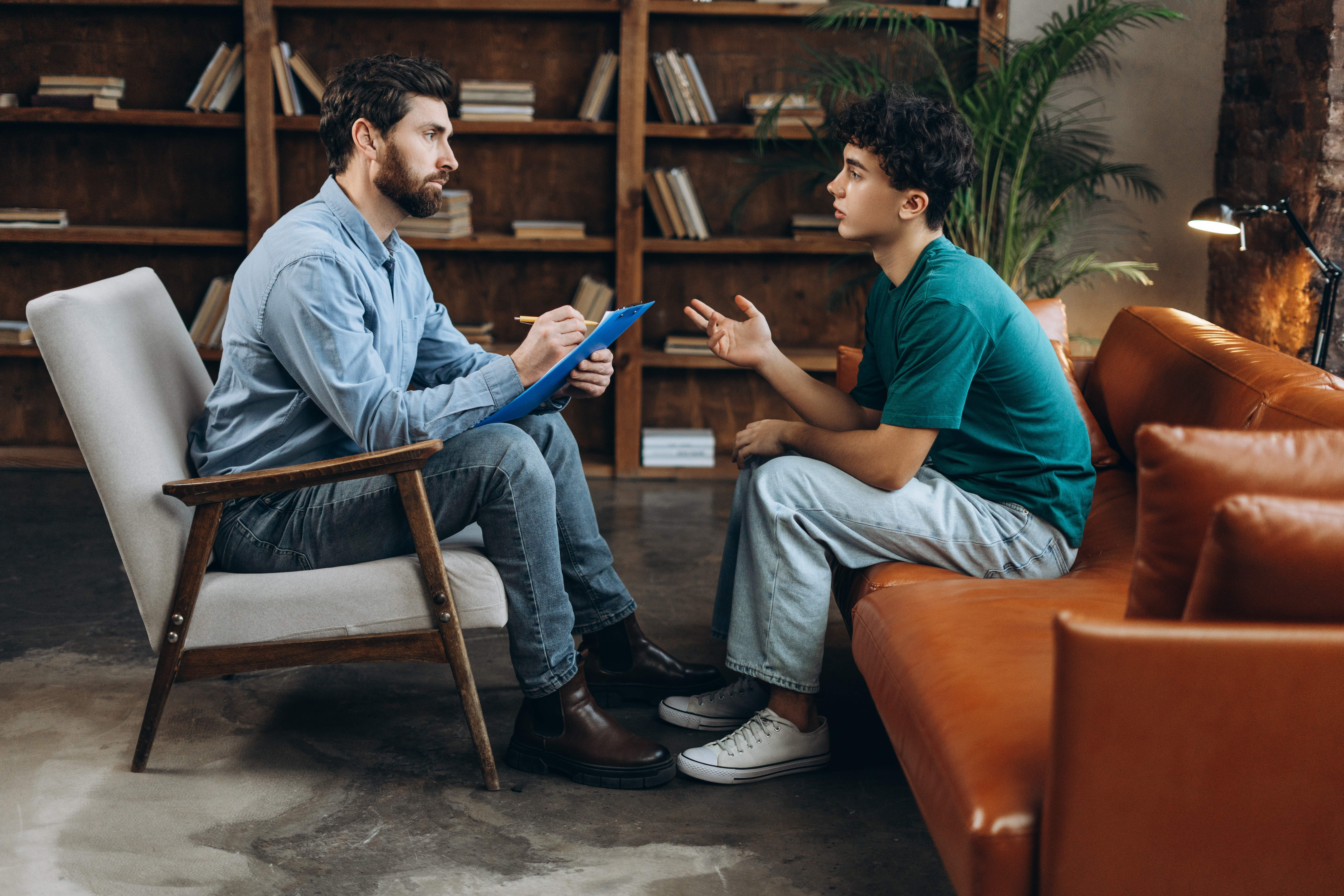 two man sitting and talking